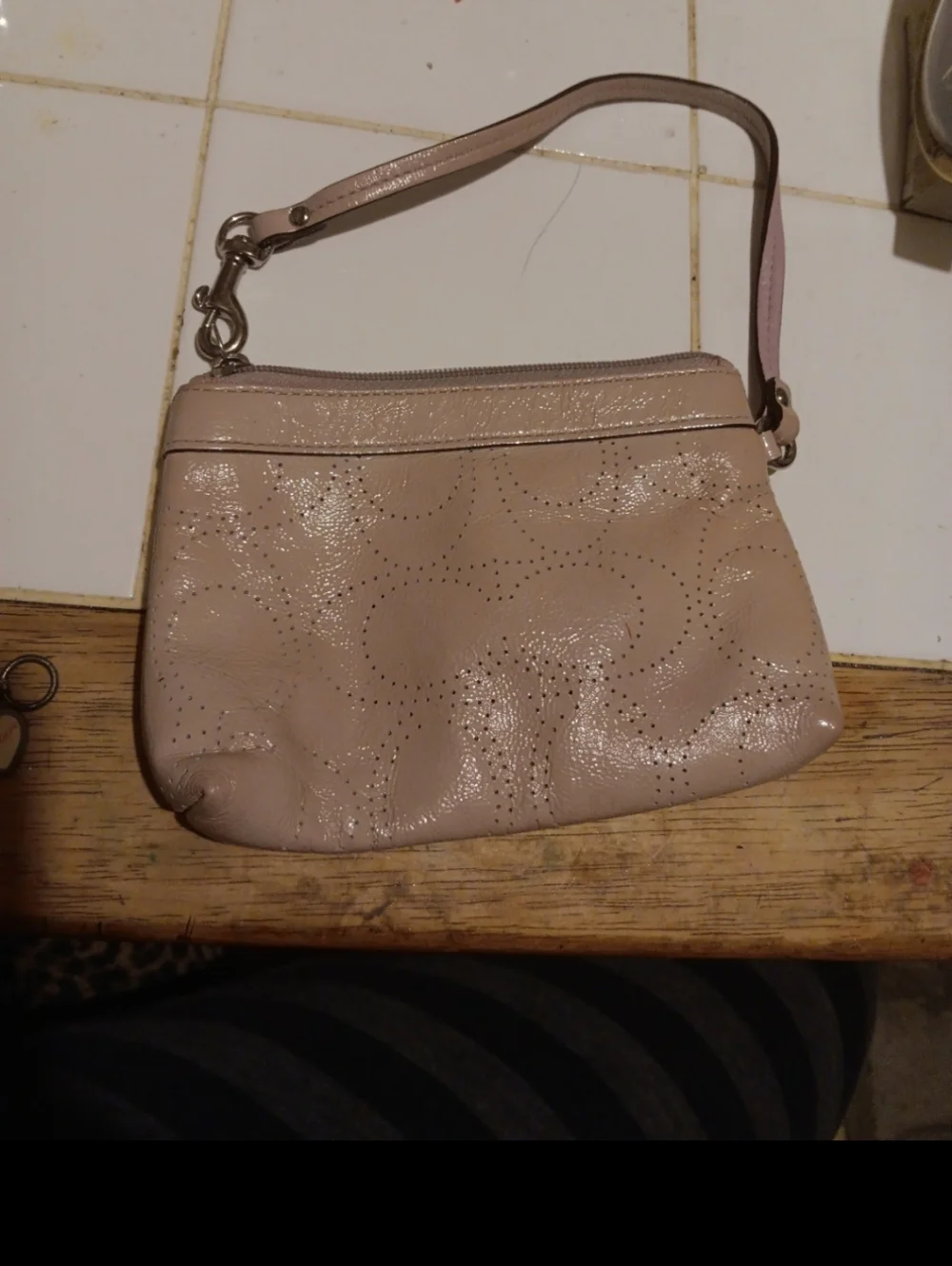 mauve-colored Coach Leather Perforated C Wristlet, Small Stain - Picture 2 of 4